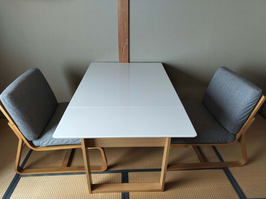 ROOMS Room 303: white table with two low cushioned chairs on tatami
